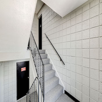 stairwell with white brick walls